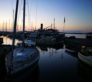 Boats in marina at sunset