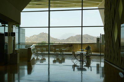 Chairs at airport against sky