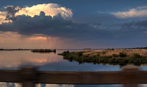 Scenic view of lake against sky during sunset