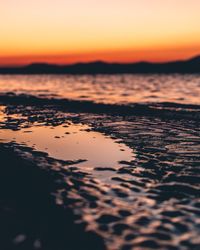 Scenic view of beach against sky during sunset