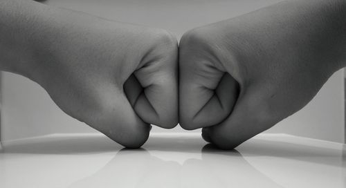 Close-up of hands against white background