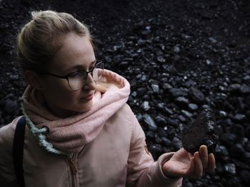 Portrait of woman holding ice cream outdoors