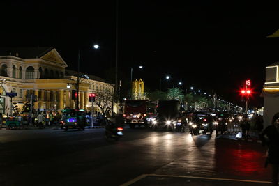 Illuminated city street and buildings at night