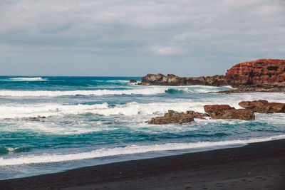 View of beach against cloudy sky