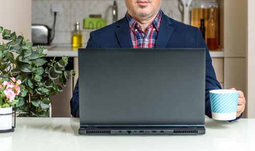 Man using laptop on table