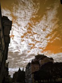 Low angle view of buildings against sky at sunset