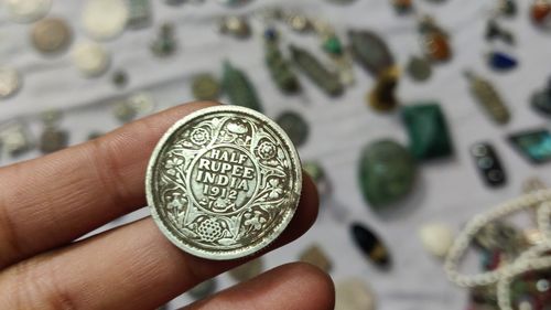 Close-up of hand holding coins