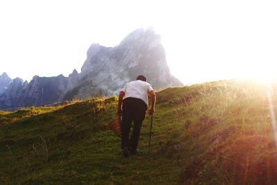 Rear view of woman standing on mountain landscape