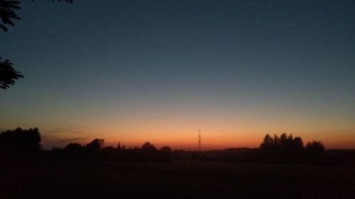 Scenic view of silhouette landscape against clear sky during sunset