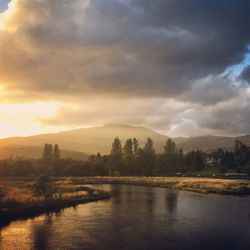 Scenic view of lake against sky at sunset