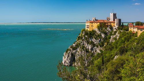 Gulf of trieste. high cliffs between boats, karst rocks and ancient castles. duino. italy