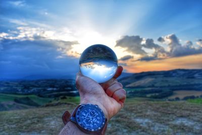 Close-up of hand holding crystal ball