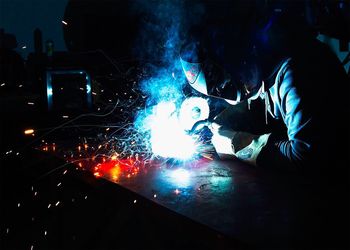 Side view of a welder at work