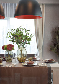 Flower vase on table at home