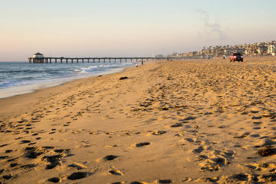 Scenic view of beach against sky during sunset