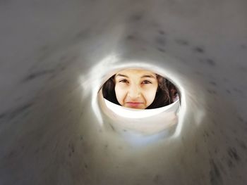 Close-up of girl looking through tube