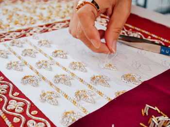 Cropped hand embroidering jewelry