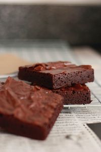 Close-up of chocolate brownies on newspaper