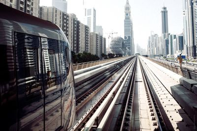 Railroad tracks amidst buildings in city