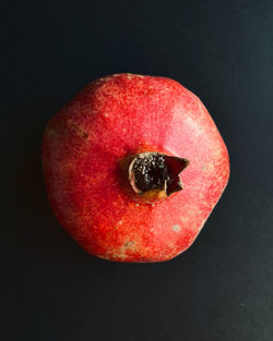 Close-up of red apple against black background