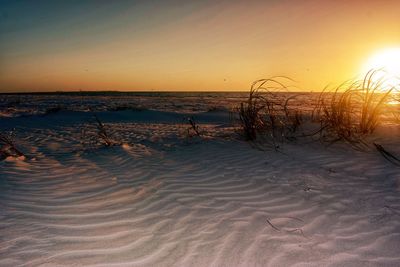 Scenic view of beach against sky during sunset