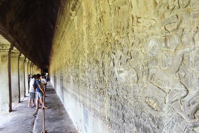 Rear view of woman walking in corridor