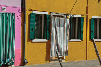 Colorful houses and doors with curtain in burano, a little town full of canals near venice, italy.