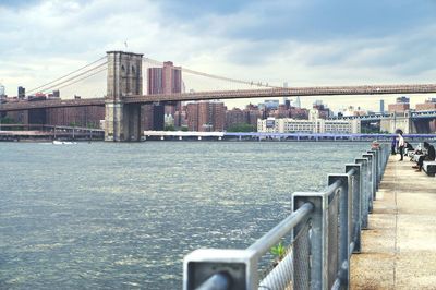 Bridge over river with city in background