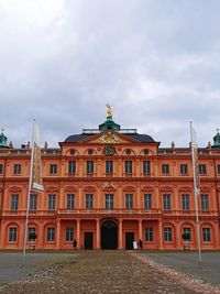 Low angle view of building against cloudy sky