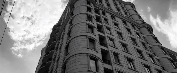 Low angle view of building against cloudy sky