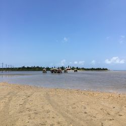 Scenic view of beach against blue sky