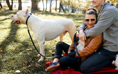 Side view of woman with dog on field