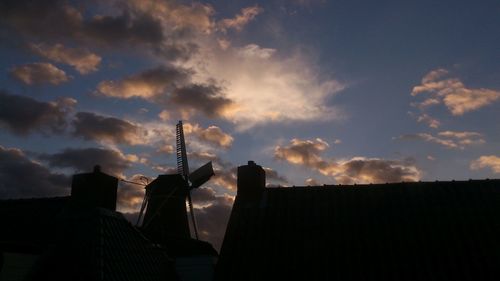 Low angle view of buildings against cloudy sky