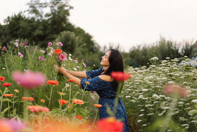 A young woman prune flowers in a floristic flower farm. woman florist.