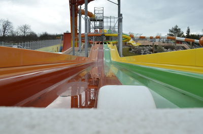 High angle view of colorful water slides against sky
