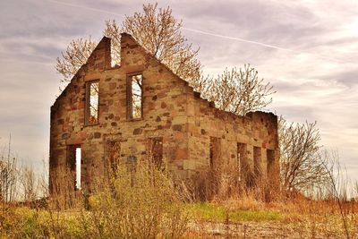 Low angle view of old house against sky