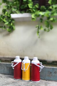 Close-up of bottles on sidewalk