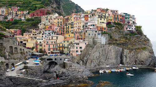 Panoramic view of sea by cliff against sky