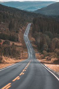 Empty road by mountain