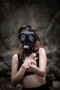 Portrait of woman holding mask