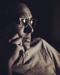 Close-up of thoughtful man in darkroom