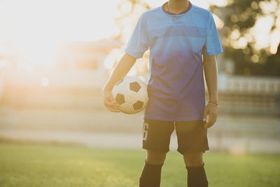 Man playing soccer ball on field