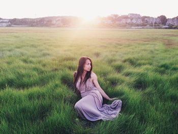 People relaxing on grassy field