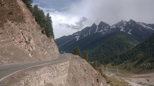 Road amidst mountains against sky