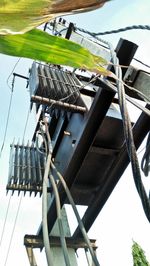 Low angle view of cranes against sky