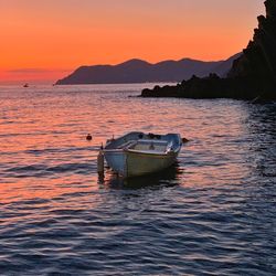 Sunset with boat in foreground at riomaggiore, italy