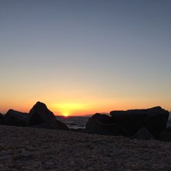 Scenic view of sea against clear sky during sunset
