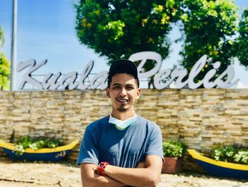 Portrait of a smiling young man standing outdoors