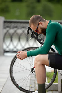 Rear view of man riding bicycle