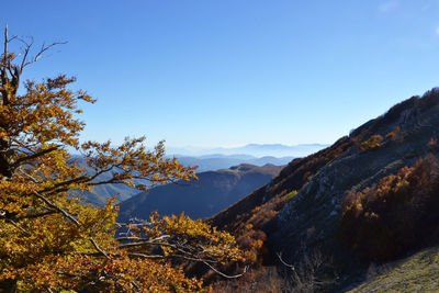 Scenic view of mountains against blue sky